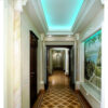 Installed Cathedral & Vaulted Ceiling Molding for Indirect Lighting creating a glowing recessed ceiling detail in an elegant hallway interior.