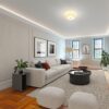 Installed Cincinnati 3-Step Molding for Indirect Lighting creating soft perimeter ceiling illumination in a contemporary living room.