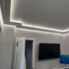 Installed New York 2-Way Molding for Indirect Lighting creating soft perimeter ceiling illumination in a contemporary interior.