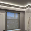 Installed New York 2-Way Molding for Indirect Lighting creating soft perimeter ceiling illumination in a contemporary interior.