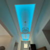 Installed Asheville Molding for Indirect Lighting creating illuminated recessed ceiling details in a tall foyer interior.