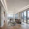 Installed New York Baseboard Molding adding a crisp architectural finish to a refined contemporary interior with floor-to-ceiling windows.