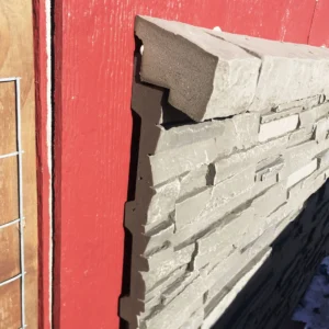 Volcano Ash Stacked Stone Panel Installation on a red house