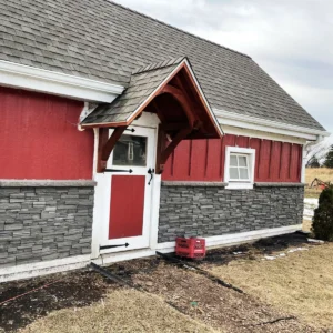 Volcano Ash Stacked Stone Panel Installation on a red house