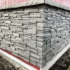 Volcano Ash Stacked Stone Panel Installation on a red house