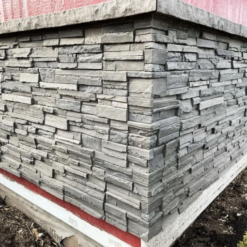 Volcano Ash Stacked Stone Panel Installation on a red house