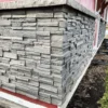 Volcano Ash Stacked Stone Panel Installation on a red house