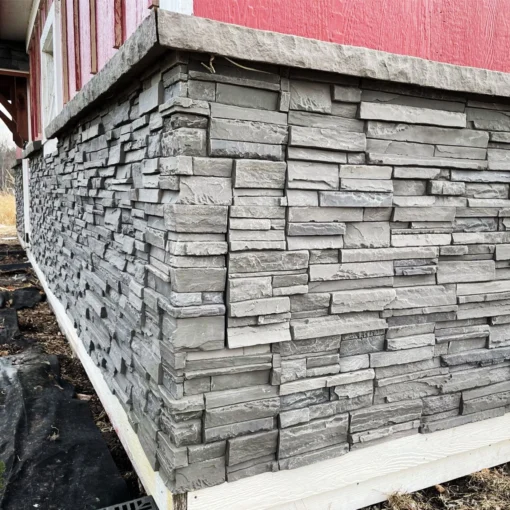 Volcano Ash Stacked Stone Panel Installation on a red house