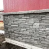 Volcano Ash Stacked Stone Panel Installation on a red house